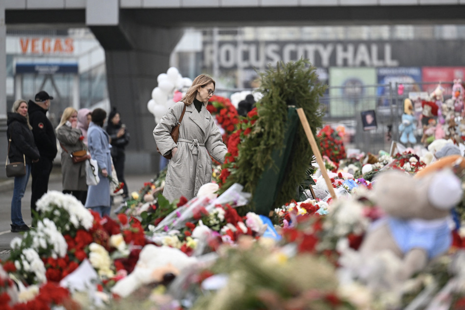 People visit a makeshift memorial in front of the Crocus City Hall in Moscow's northern suburb of Krasnogorsk on March 29, 2024.