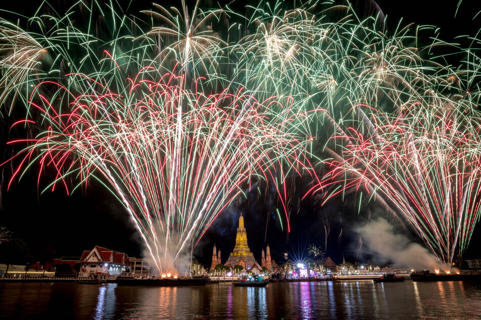 A fireworks show is seen over Wat Arun Buddhist temple on the Chao Phraya River in Bangkok.