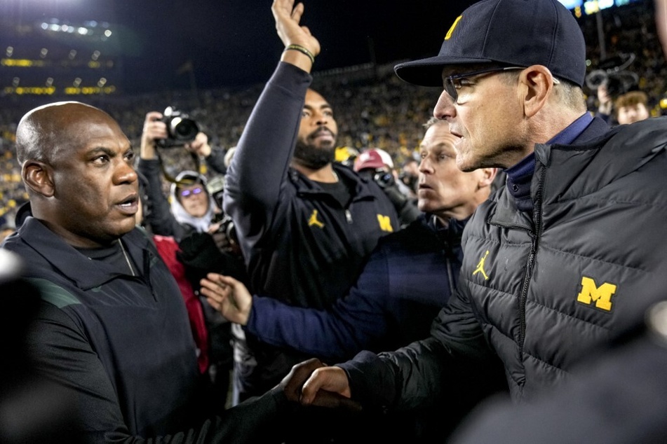 Wolverines head coach Jim Harbaugh (r) will seek legal against against Spartans head coach Mel Tucker (l) football players who were responsible for the brutal altercation that followed after their teams football game on Saturday.
