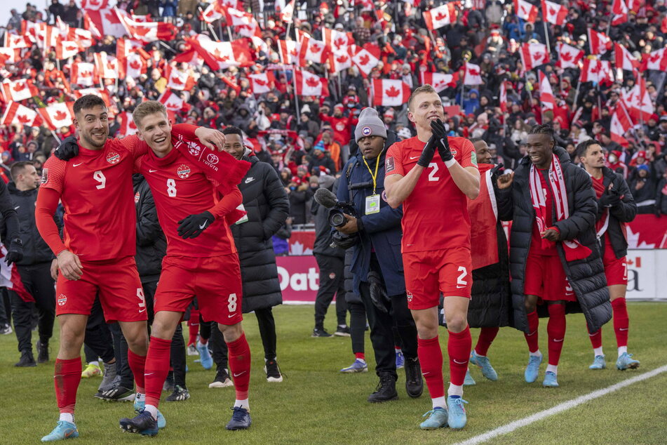 Canada's national soccer team celebrate after clinching a spot at the 2022 World Cup.