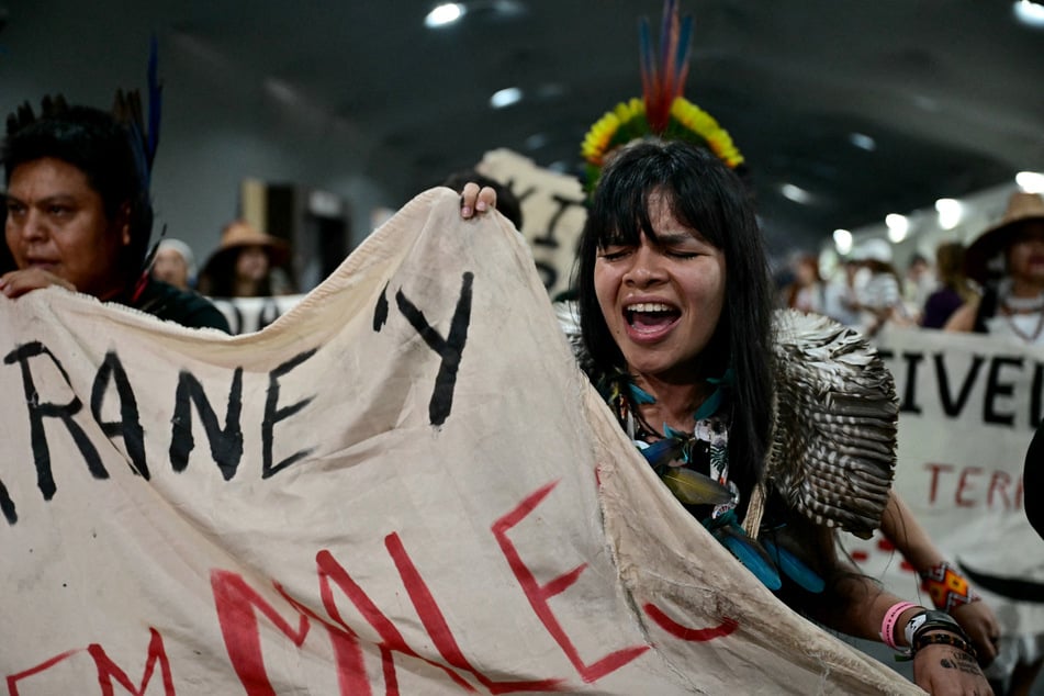 Indigenous leader and climate activist Txai Surui joins protests while leaving a plenary session during COP30 in Belem, Brazil, on November 21, 2025.