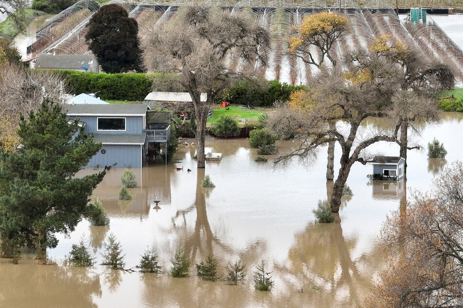 An aerial view of a home submerged in floodwater after the Salinas River overflowed its banks on January 13, 2023.