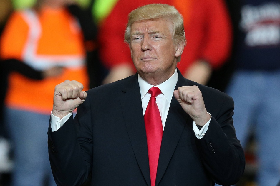 Donald Trump in the middle of his famous "fist pump" dance during a rally in Richfield, Ohio on March 29, 2018.