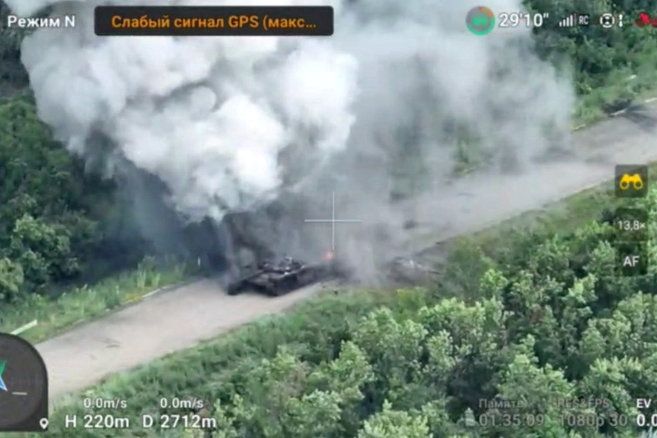 A destroyed Russian tank smolders near the city of Bakhmut, as Ukraine reports Russian troops on the frontline advancing.