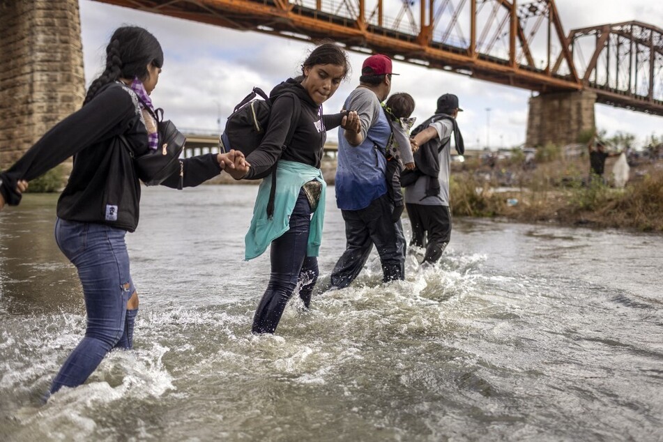 Venezuelan migrants cross the Rio Grande from Mexico into the United States in Eagle Pass, Texas.