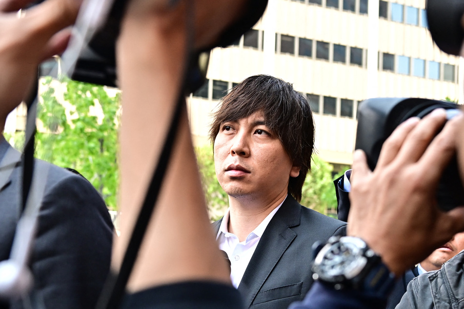 Ippei Mizuhara (c.) has agreed to plead guilty over charges of illegally transferring nearly $17 million from Shohei Ohtani's bank account in order to pay off gambling debts.