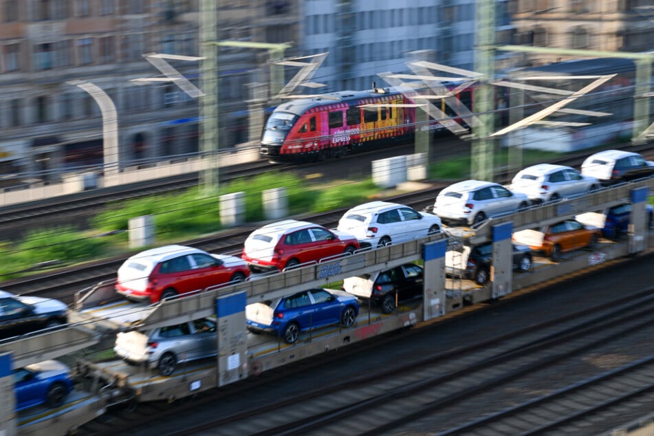 Ein Güterzug transportiert Skoda-Neuwagen durch einen Bahnhof in Dresden.