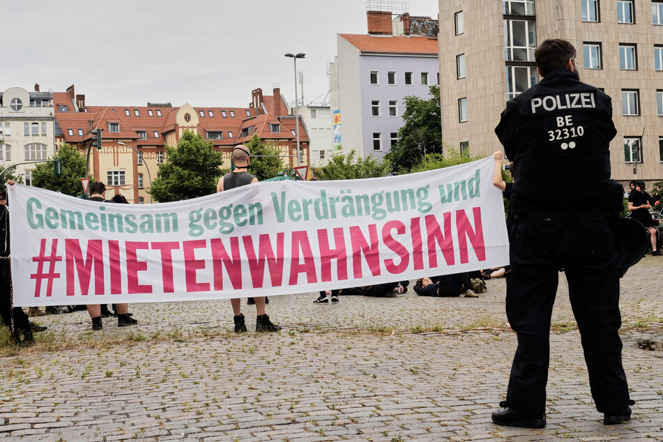 Demonstranten halten ein Transparent mit der Aufschrift "Gemeinsam gegen Verdrängung und Mietenwahnsinn" vor dem Dragoner-Areal in Berlin-Kreuzberg.
