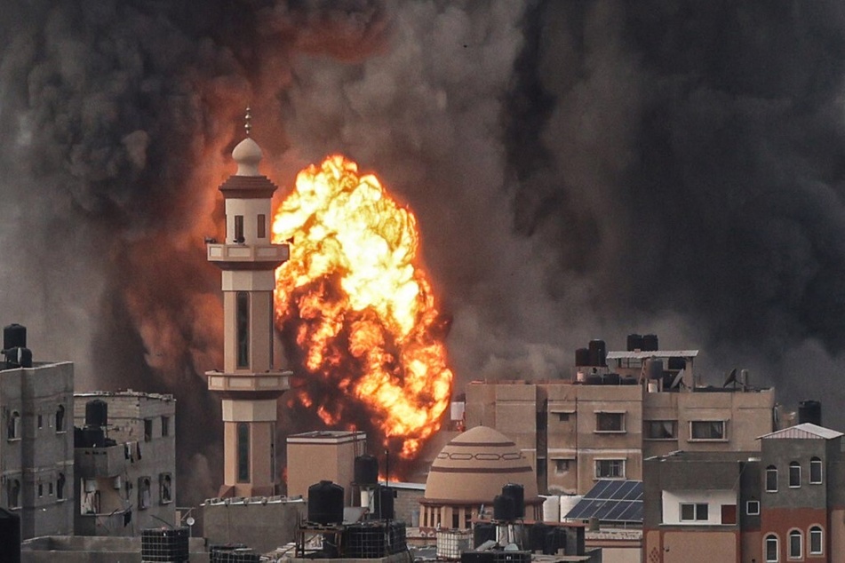 A fireball erupts after Israeli strike over Rafah in the southern Gaza Strip on December 20, 2023.