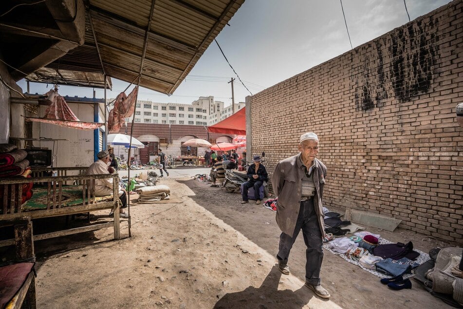 A Uighur man walks down an alleyway at the Kashgar bazaar. The Chinese government has issued a crackdown in the majority-Muslim province of Xinjiang and established a network of internment camps.