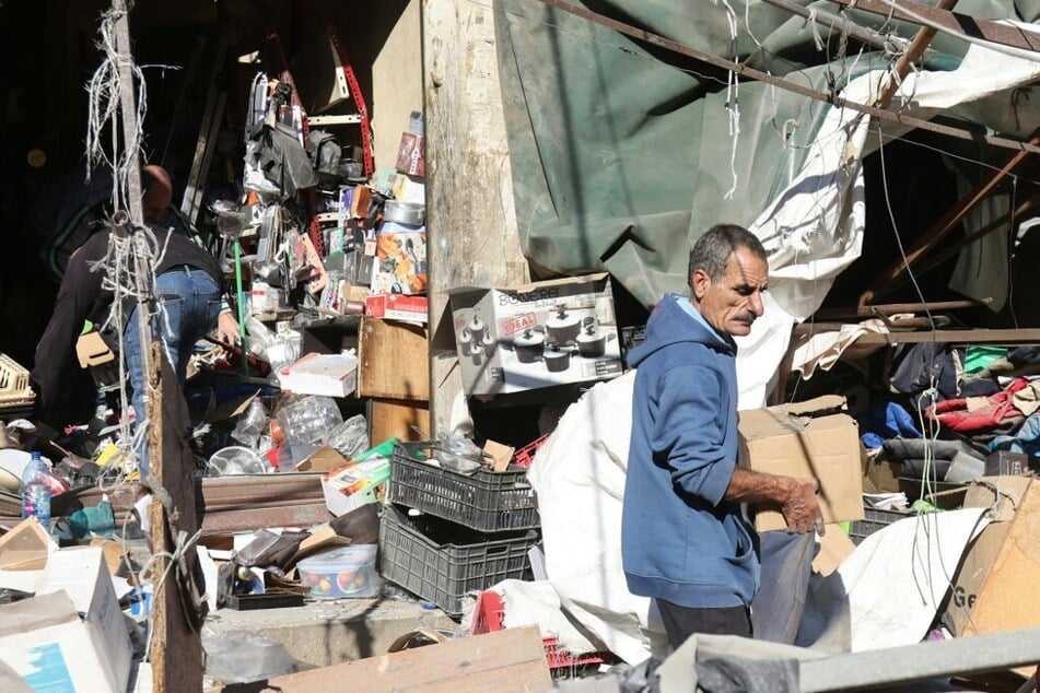 Residents search for belongings from the site of an overnight Israeli airstrike on Beirut's southern suburbs on November 15, 2024.