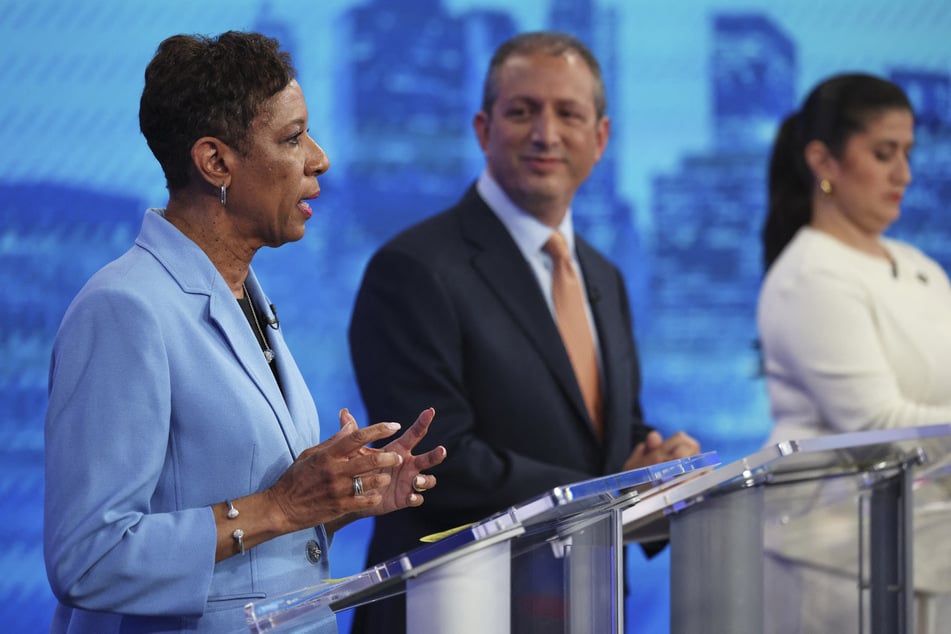 Mayoral candidate Adrienne Adams (l.) speaks as Brad Lander (c.) and Jessica Ramos (r.) listen during the Democratic primary debate.