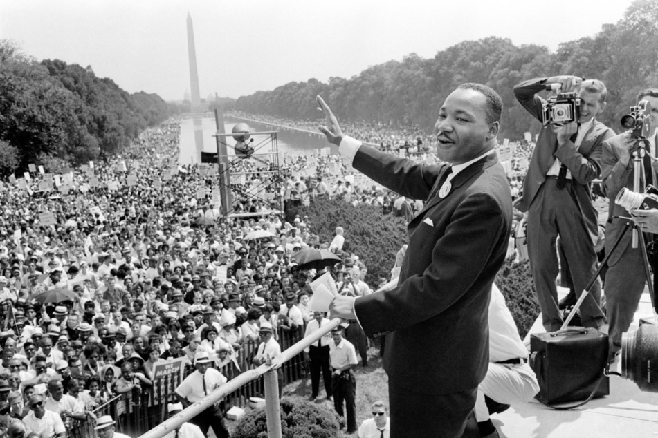 Civil rights leader Martin Luther King waving to supporters during the March on Washington for Jobs and Freedom in Washington DC on August 28, 1963.