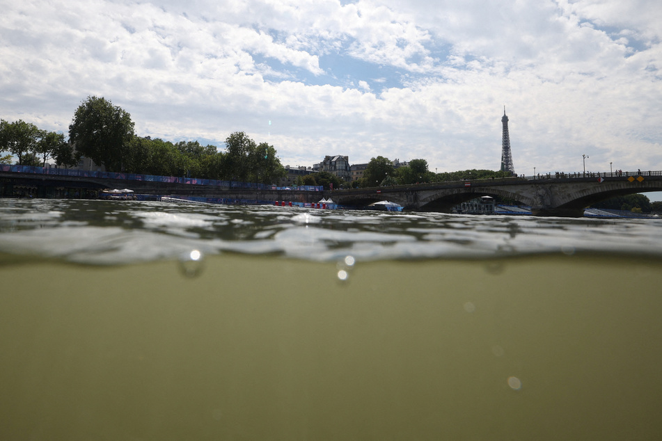 The Eiffel Tower is visible from the Triathlon start in the River Seine after training was canceled amid water quality concerns.