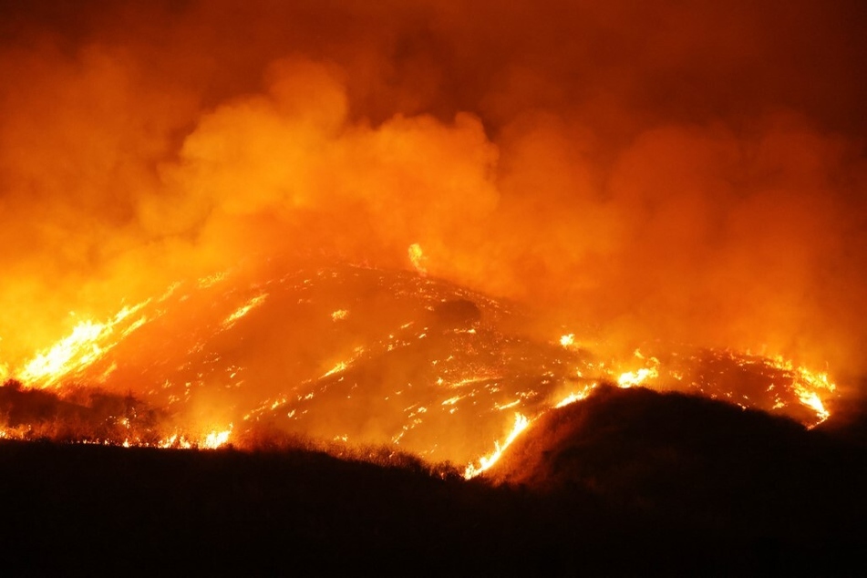 The Rabbit Fire burns in Moreno Valley in Riverside County, California, as an extended heat wave continues to bring high temperatures to the area.