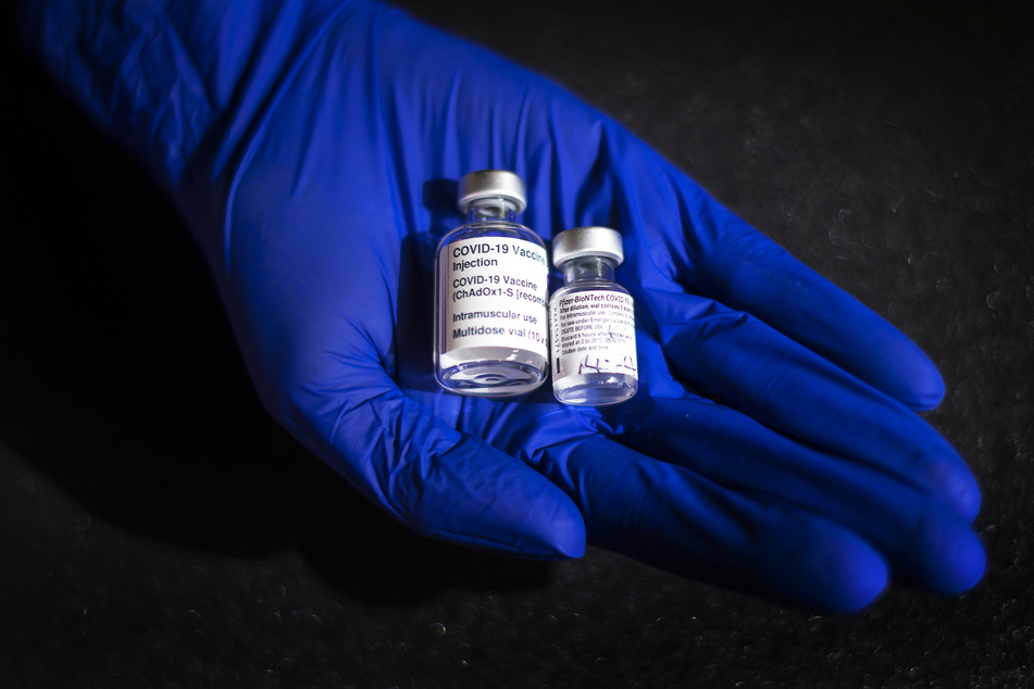Ein Arzt hält zwei Ampullen mit Corona-Impfstoffen von von Astrazeneca (l.) und Biontech/Pfizer.