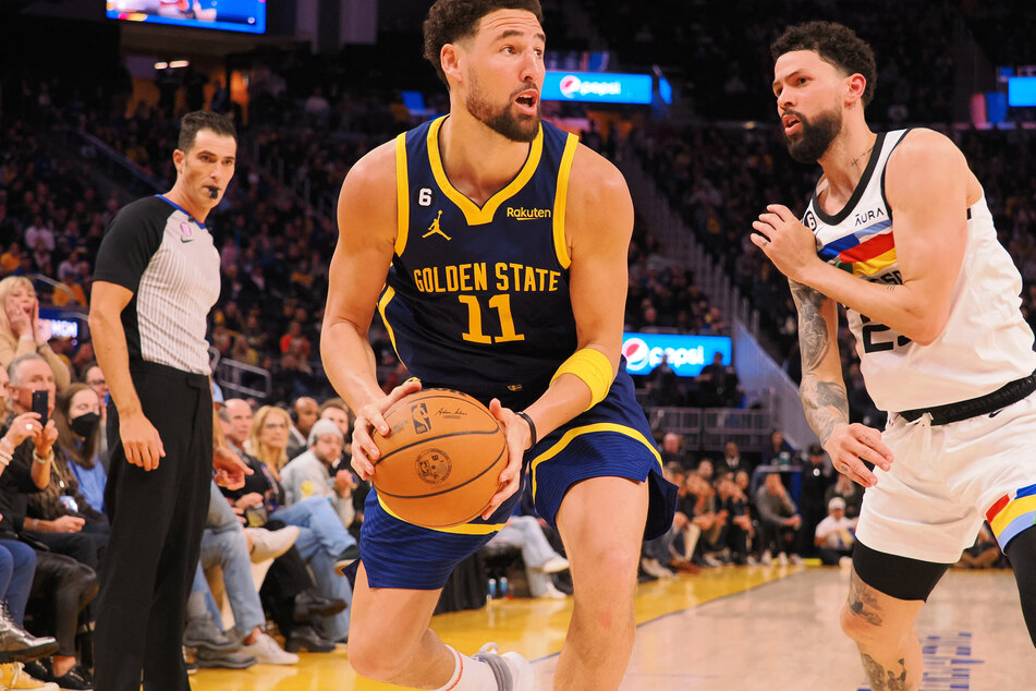 Golden State Warriors guard Klay Thompson looks toward the basket before making a three-pointer against Minnesota Timberwolves guard Austin Rivers during the fourth quarter at Chase Center.