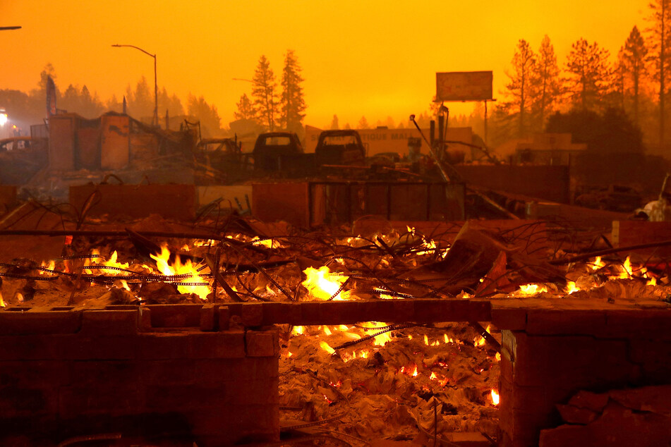 A business that was destroyed by the Camp Fire continues to smolder on November 9, 2018, in Paradise, California.