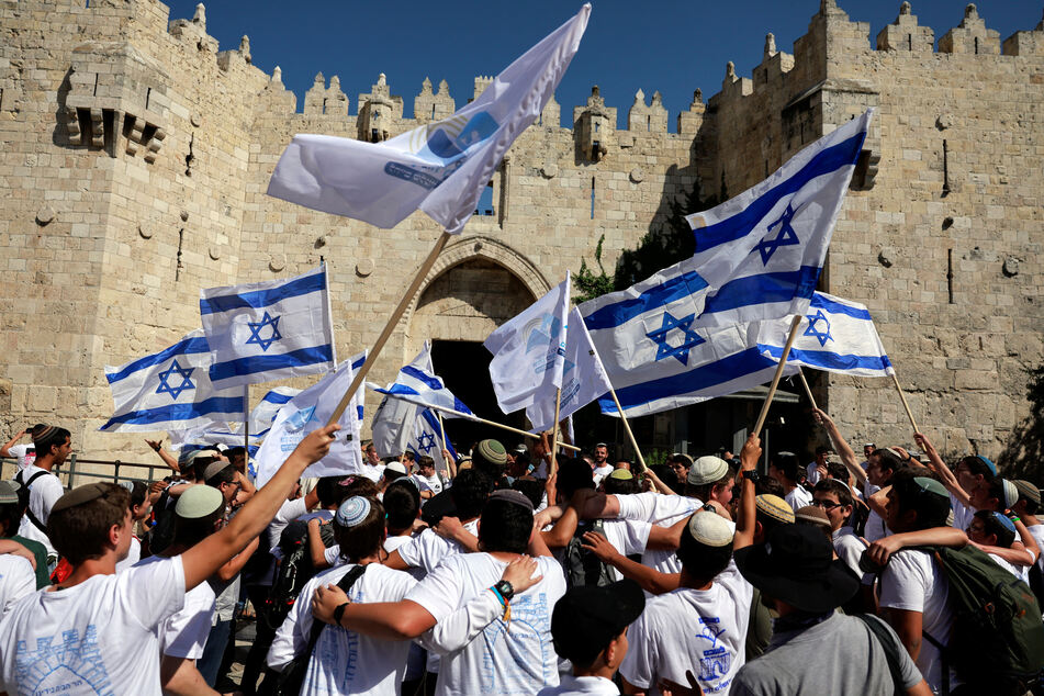Israelis wave flags as they make their way toward Damascus Gate in East Jerusalem for the annual nationalist Flag March.