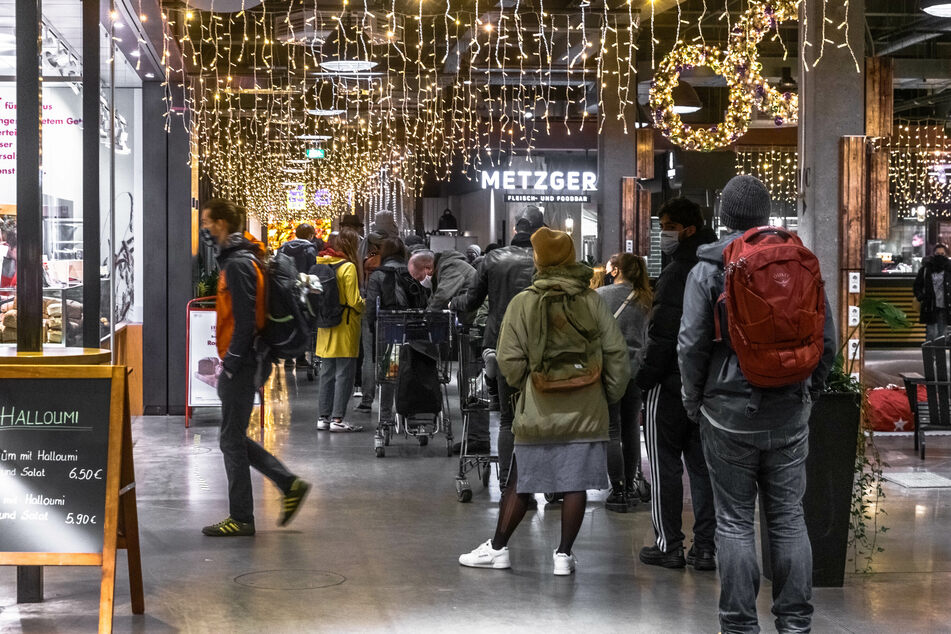 Kunden stehen im Hamburger Einkaufszentrum Rindermarkthalle vor einem Supermarkt in der Schlange.
