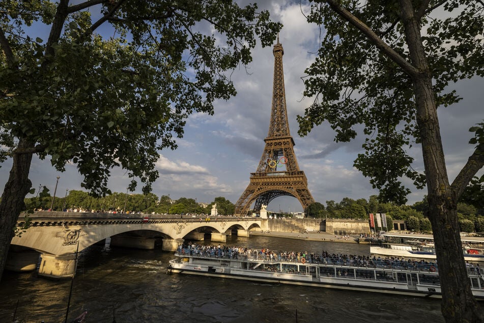 A tourist boat sails under the Pont de lena bridge on the Seine River in Paris on Wednesday.