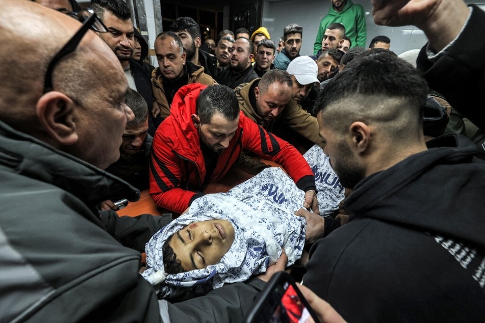 Mourners carry the body of Palestinian teenager Ahmad Rushdi, who was killed during an Israeli military attack in the village of Sebastia, at the Rafidia hospital in Nablus in the north of occupied West Bank.