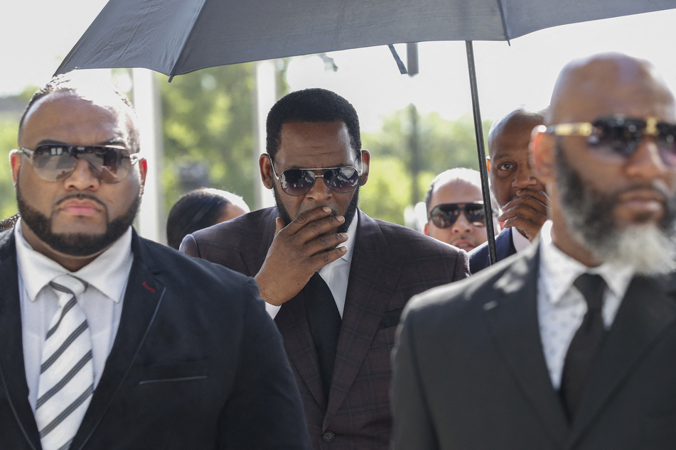 R. Kelly (c.) is again facing a month-long trial and possible decades more in prison.