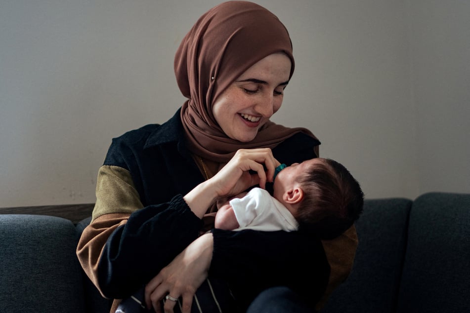 Dr. Noor Abdalla holds Deen, the baby son she shares with her husband Mahmoud Khalil.