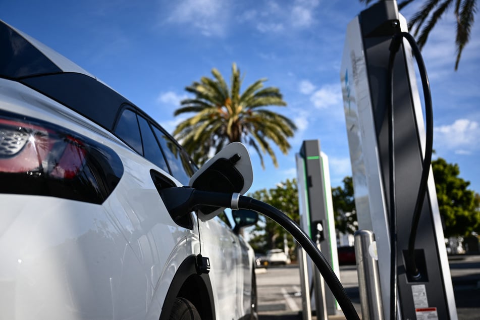 A Volkswagen ID.4 electric vehicle charges at a shopping mall parking lot in Torrance, California.