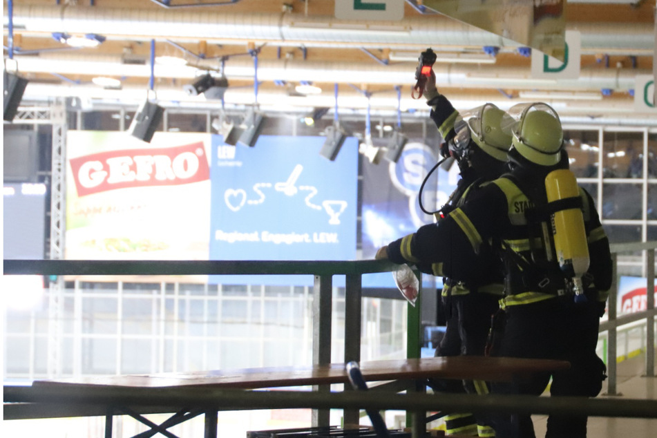 Feuerwehrleute messen die Konzentration von Kohlenmonoxid in der Eissporthalle.