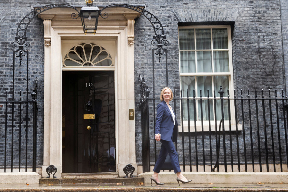 Liz Truss walks outside Number 10 Downing Street in London.