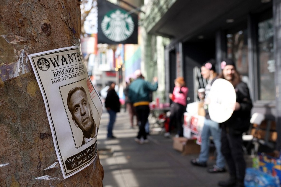 A "Wanted" poster of Howard Schultz is posted on a tree as striking Starbucks workers picket in San Francisco, California.