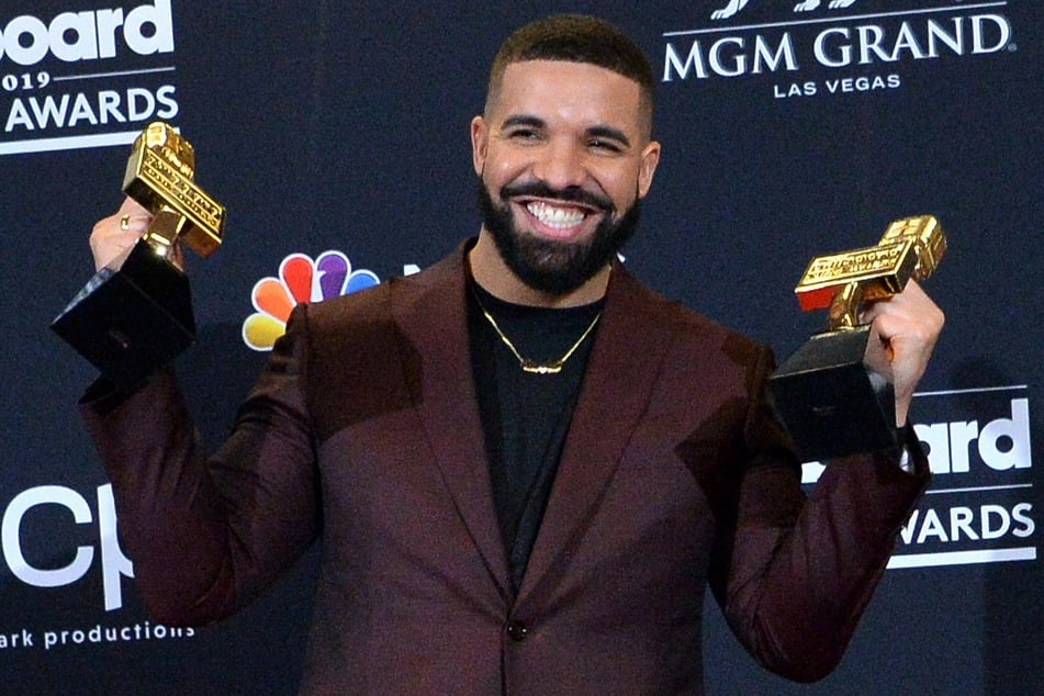 Canadian R&amp;B star Drake poses with two of his twelve awards at the 2019 Billboard Music Awards.