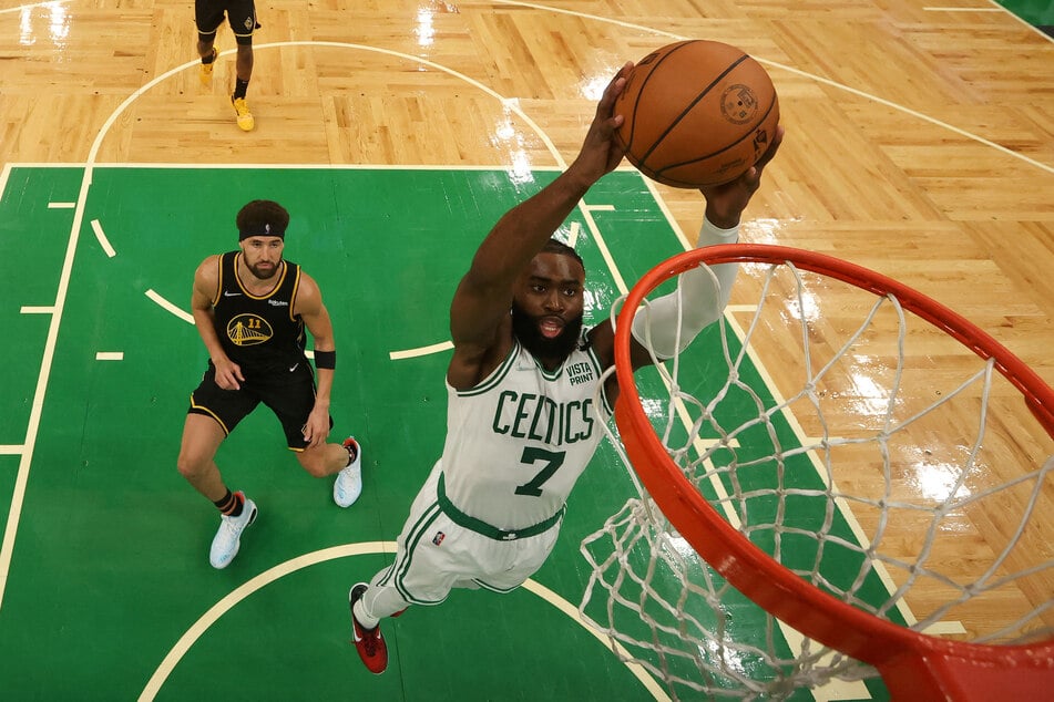 Celtics guard Jaylen Brown dunks and scores against the Golden State Warriors in the second half of Game 3 of the 2022 NBA Finals.