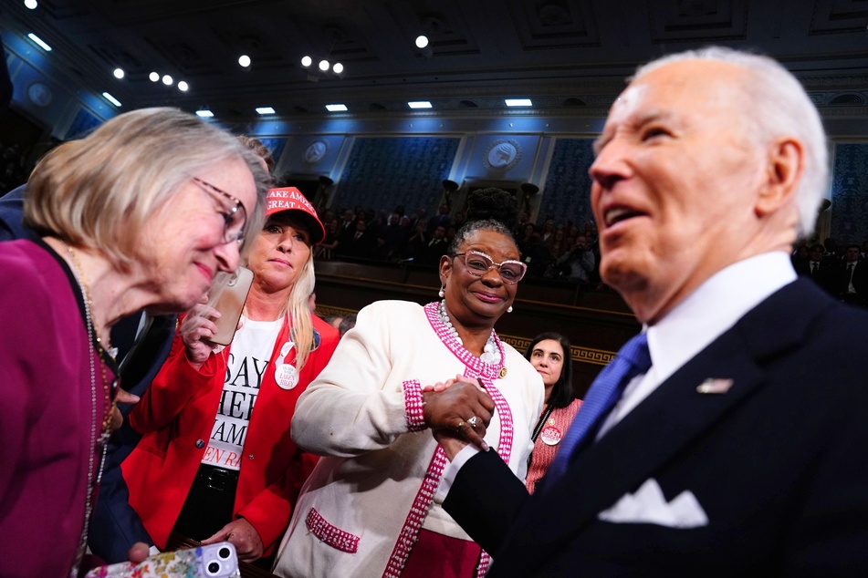 Representative Marjorie Taylor Greene (second from l.) looked on as President Joe Biden (r.) arrived to the House Chamber for his State of the Union address in Washington on Thursday.