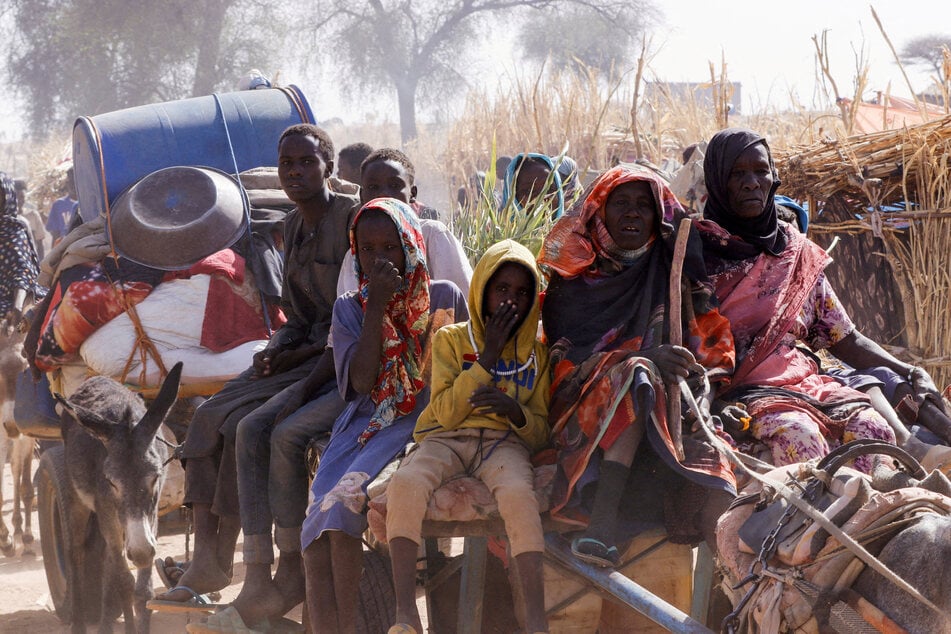 Displaced people ride on an animal-drawn cart following Rapid Support Forces attacks, in the town of Tawila, North Darfur, Sudan.