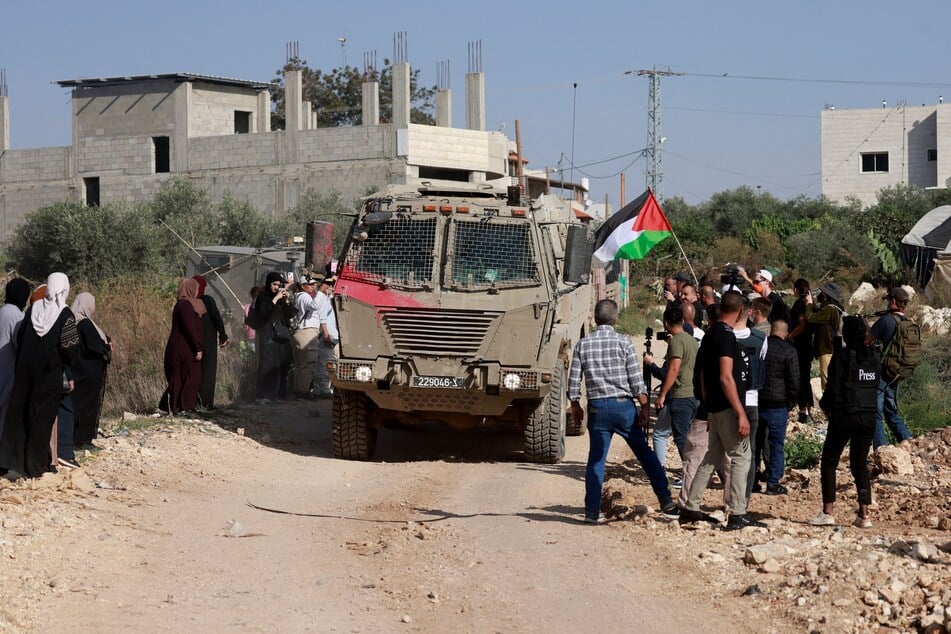 Residents of the Nur Shams refugee camp and international solidarity activists gather at the entrance of the camp during a protest demanding the right of Palestinians to return to their homes, on November 23, 2025.