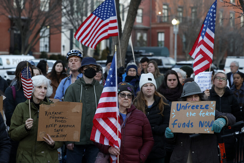 Protesters rallied in front of the White House to demand the release of federal funds suspended by the Trump administration.