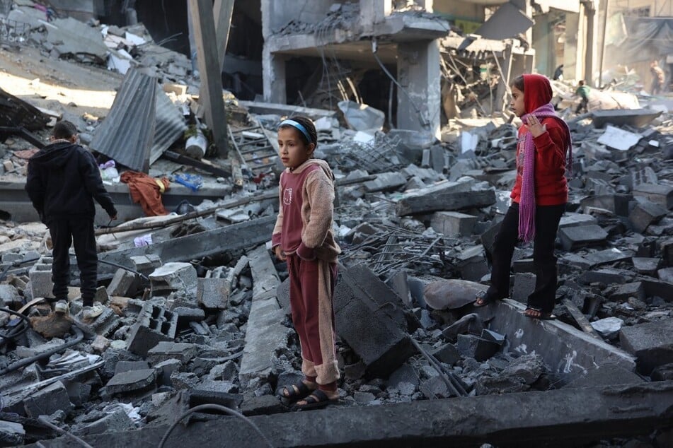 Palestinian children inspect the damage at the site of an Israeli strike the previous night in Jabalia, in the central Gaza Strip, on January 1, 2025.