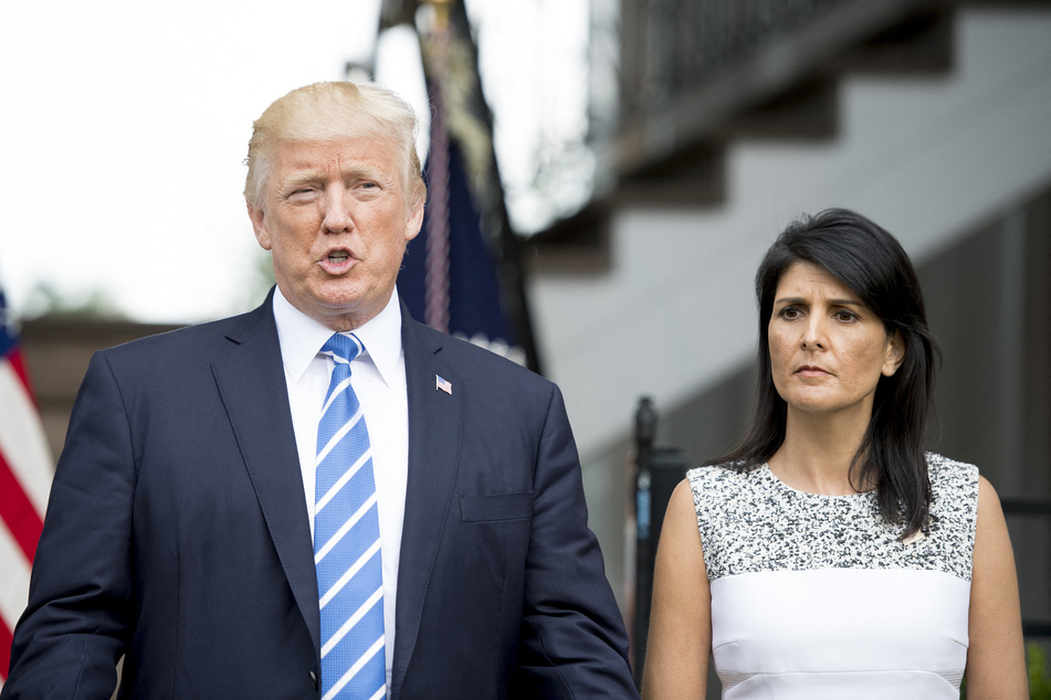 Donald Trump (l) speaks to the press with Ambassador to the United Nations Nikki Haley (r) on August 11, 2017 in Bedminster, New Jersey.