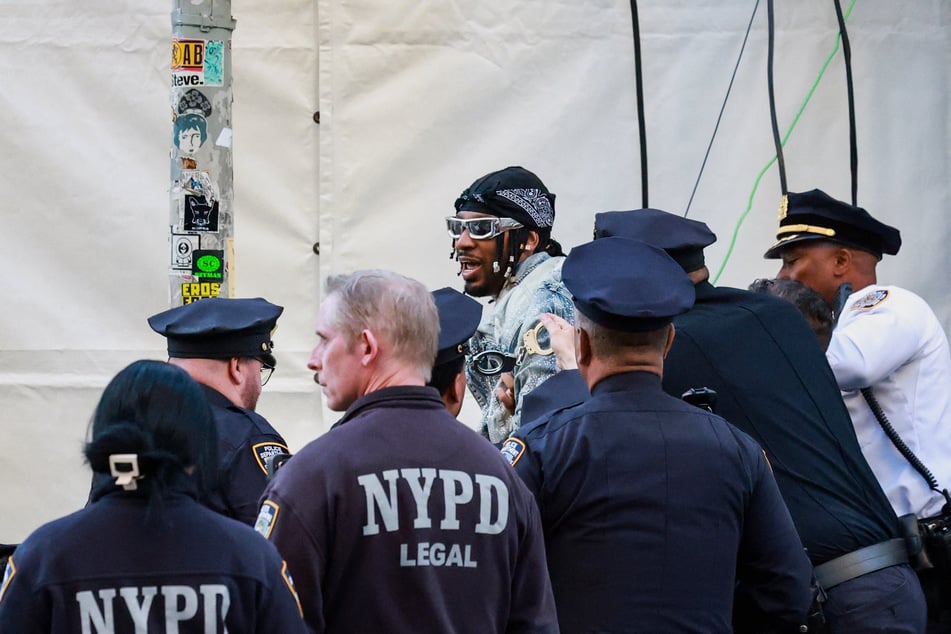 Chris Smalls is detained after trying to enter the venue with a protest sign during the Met Gala in New York City on May 4, 2026.