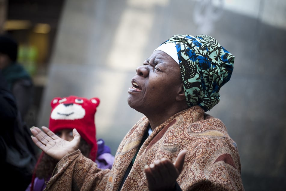 Queen Mother Dr. Delois Blakely prays at the African Burial Ground National Monument in New York City before leading Occupy the Dream demonstrators on a march to the Federal Reserve in honor of Dr. Martin Luther King Jr. on January 16, 2012.