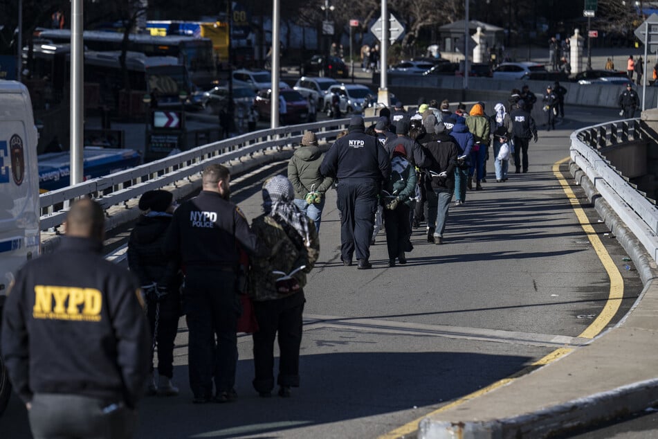 Police arrested dozens of protesters blocking the Manhattan entrance to the Brooklyn Bridge.