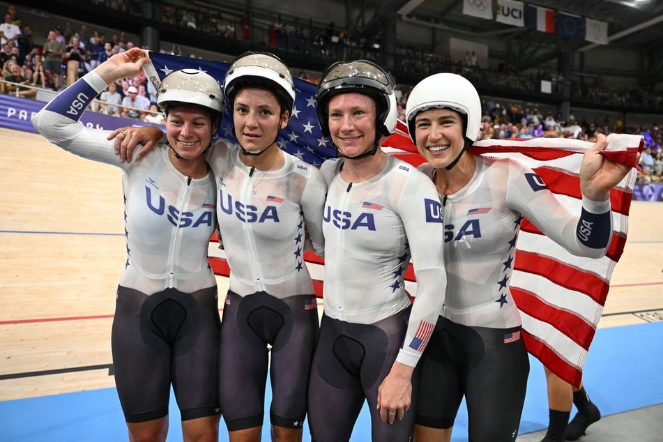 (From L) Team USA members Jennifer Valente, Chloe Dygert, Lily Williams, and Kristen Faulkner pose after winning the women's track cycling team pursuit final for gold at the Paris 2024 Olympic Games at the Saint-Quentin-en-Yvelines National Velodrome in Montigny-le-Bretonneux, south-west of Paris, on Wednesday.