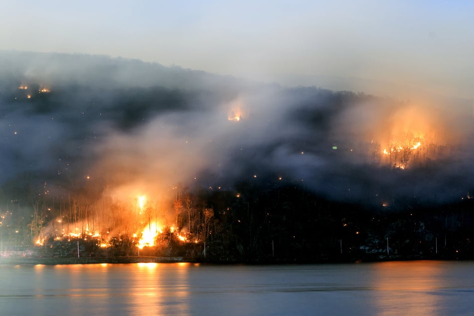 An area burns from the Jennings Creek Wildfire on November 13, 2024 in Greenwood Lake, New York. An extended drought has helped fuel the Jennings Creek Wildfire on the New York/New Jersey border, which has grown to 5,000 acres across both states.