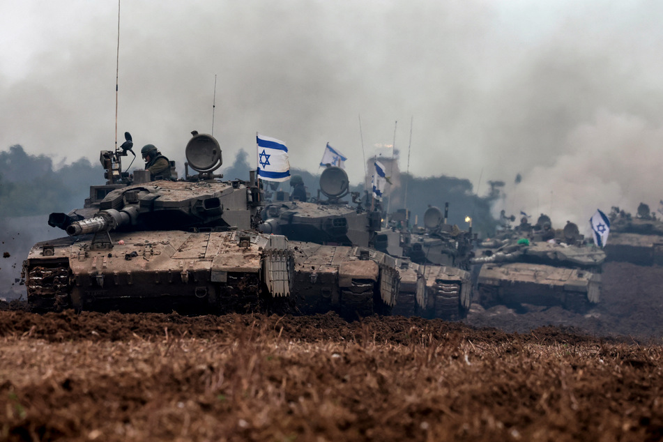 A unit of Israeli soldiers return with their tanks to the Israeli side of the border with the Gaza Strip January 28.