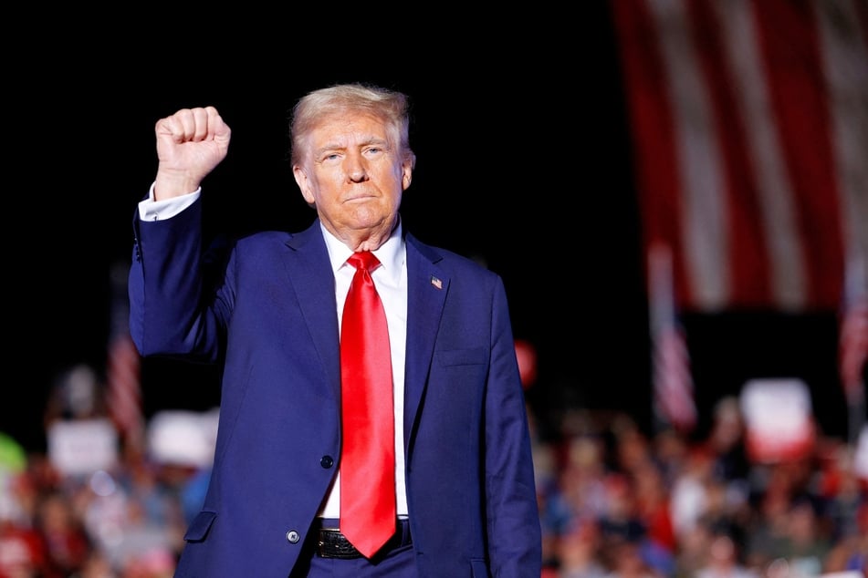 Donald Trump holding up his fist as he walks offstage at the end of a campaign rally at the Butler Farm Show fairgrounds in Butler, Pennsylvania on Saturday.