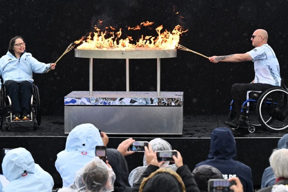 Britain's Helene Raynsford and Gregor Ewan light the Olympic cauldron during the Paralympic torch-lighting ceremony at Stoke Mandeville in Aylesbury, central England.