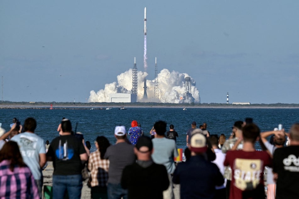 Spectators watch as a Blue Origin New Glenn rocket launches from LC-36 at the Cape Canaveral Space Force Station in Florida on November 13, 2025.