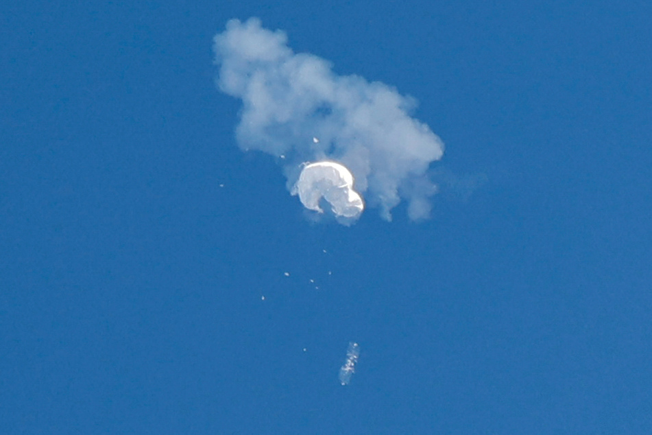 A suspected Chinese spy balloon drifts to the ocean after being shot down off the coast in Surfside Beach, South Carolina.